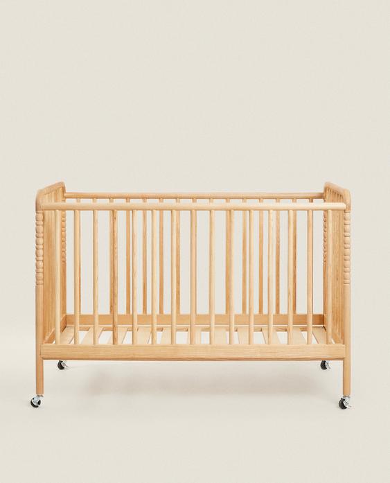 CARVED WOODEN COT WITH WHEELS
