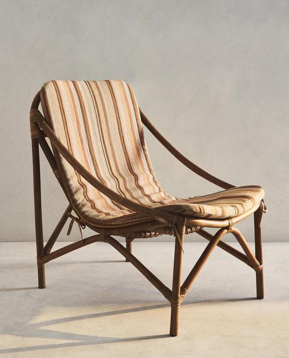 RATTAN ACCENT CHAIR AND STRIPED CUSHION