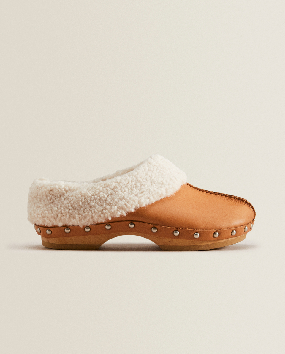 Wooden clogs with faux fur detail
