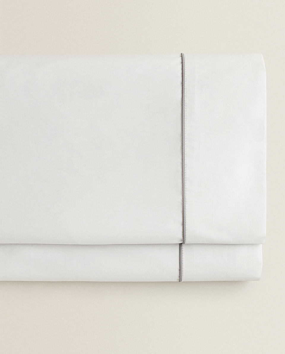 FLAT SHEET WITH CONTRASTING PIPING