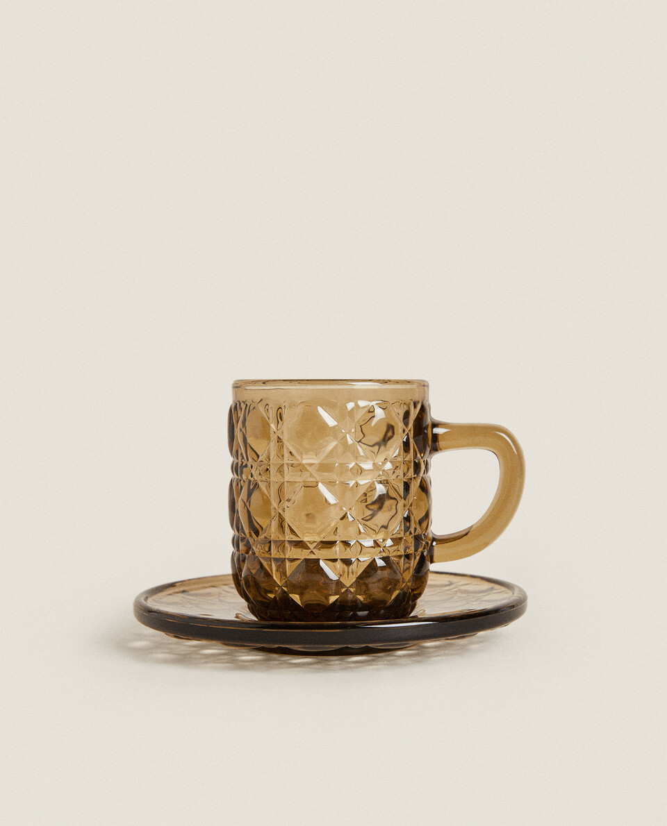 GLASS COFFEE CUP AND SAUCER WITH RAISED GEOMETRIC DESIGN