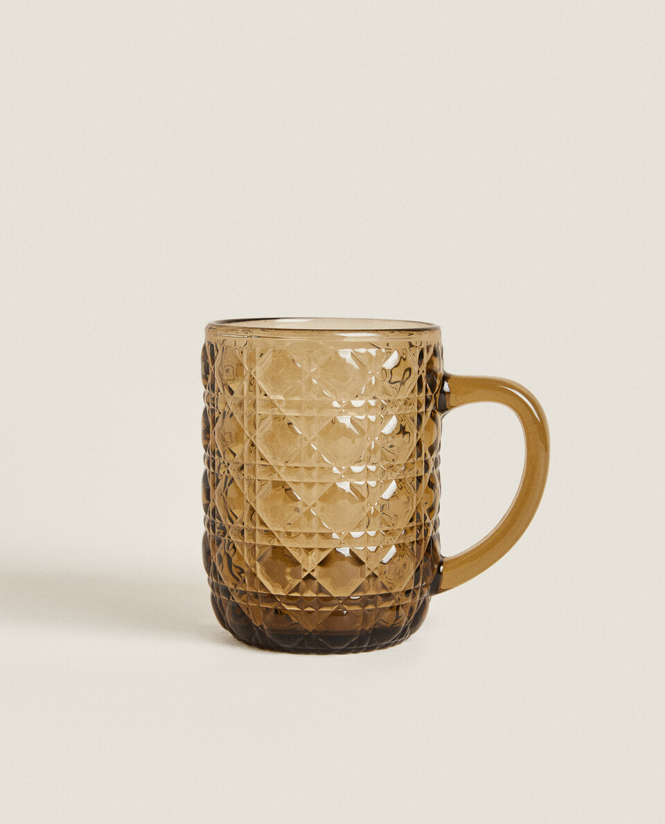 GLASS CUP WITH RAISED GEOMETRIC DESIGN