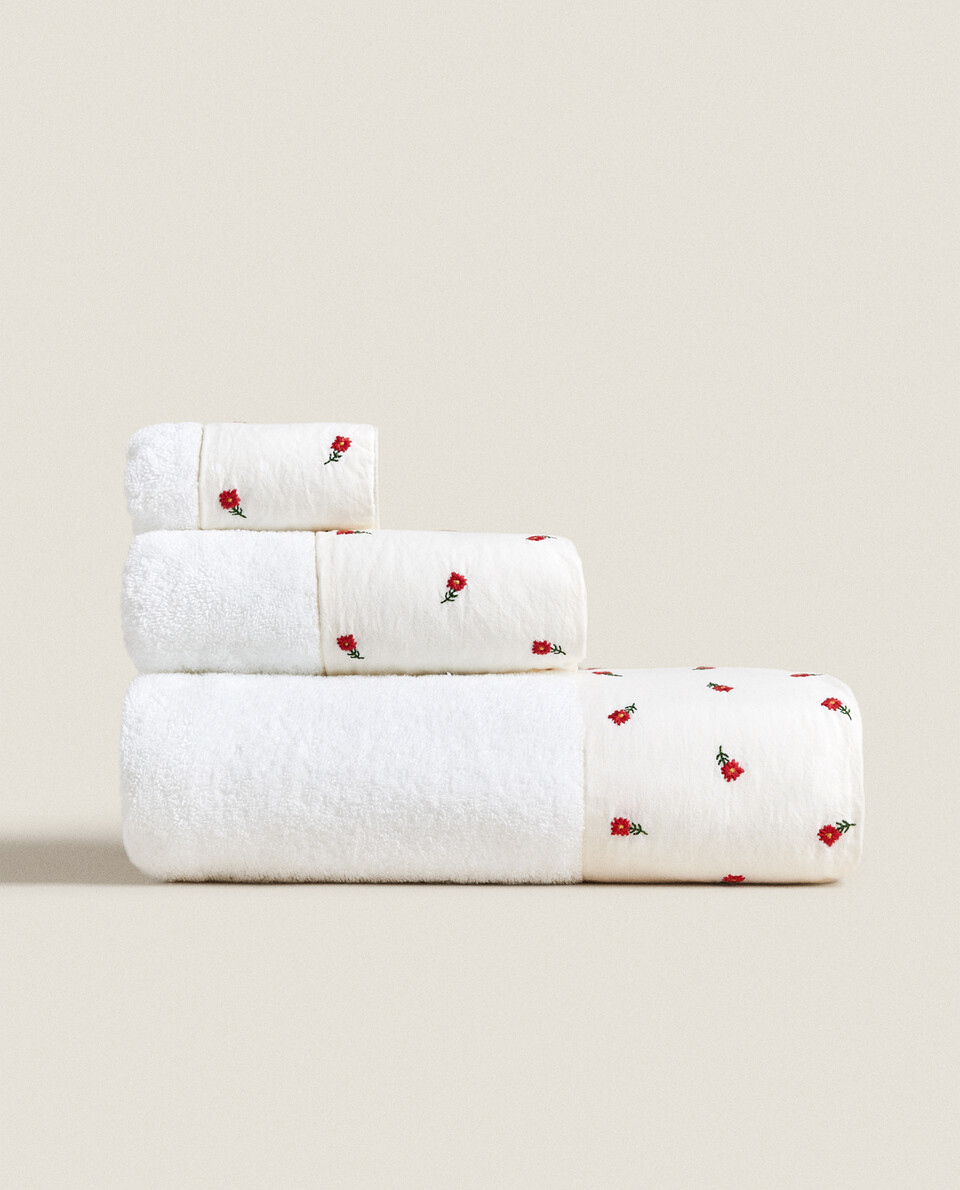 TOWEL WITH EMBROIDERED FLOWERS AND BORDER