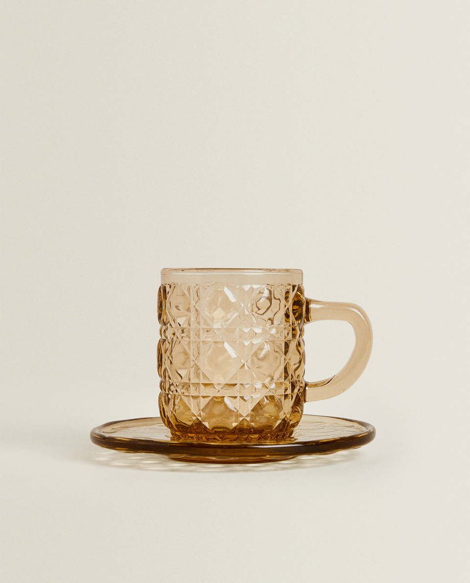 GLASS COFFEE CUP AND SAUCER WITH RAISED GEOMETRIC DESIGN