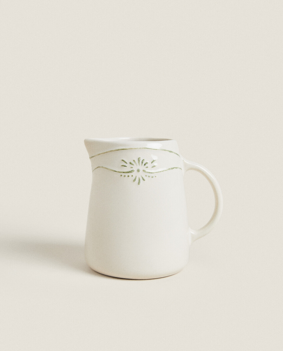 EARTHENWARE MILK PITCHER WITH RAISED CHRISTMAS DESIGN