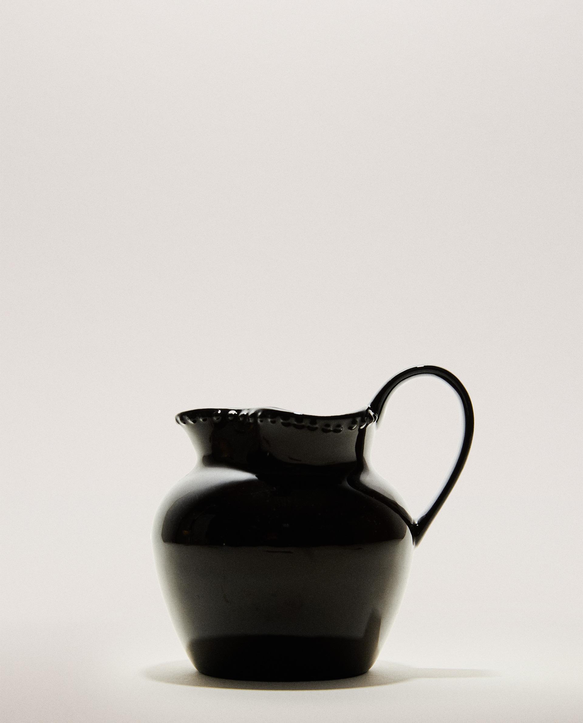 STONEWARE JUG WITH RAISED DESIGN STONEWARE JUG WITH RAISED DESIGN