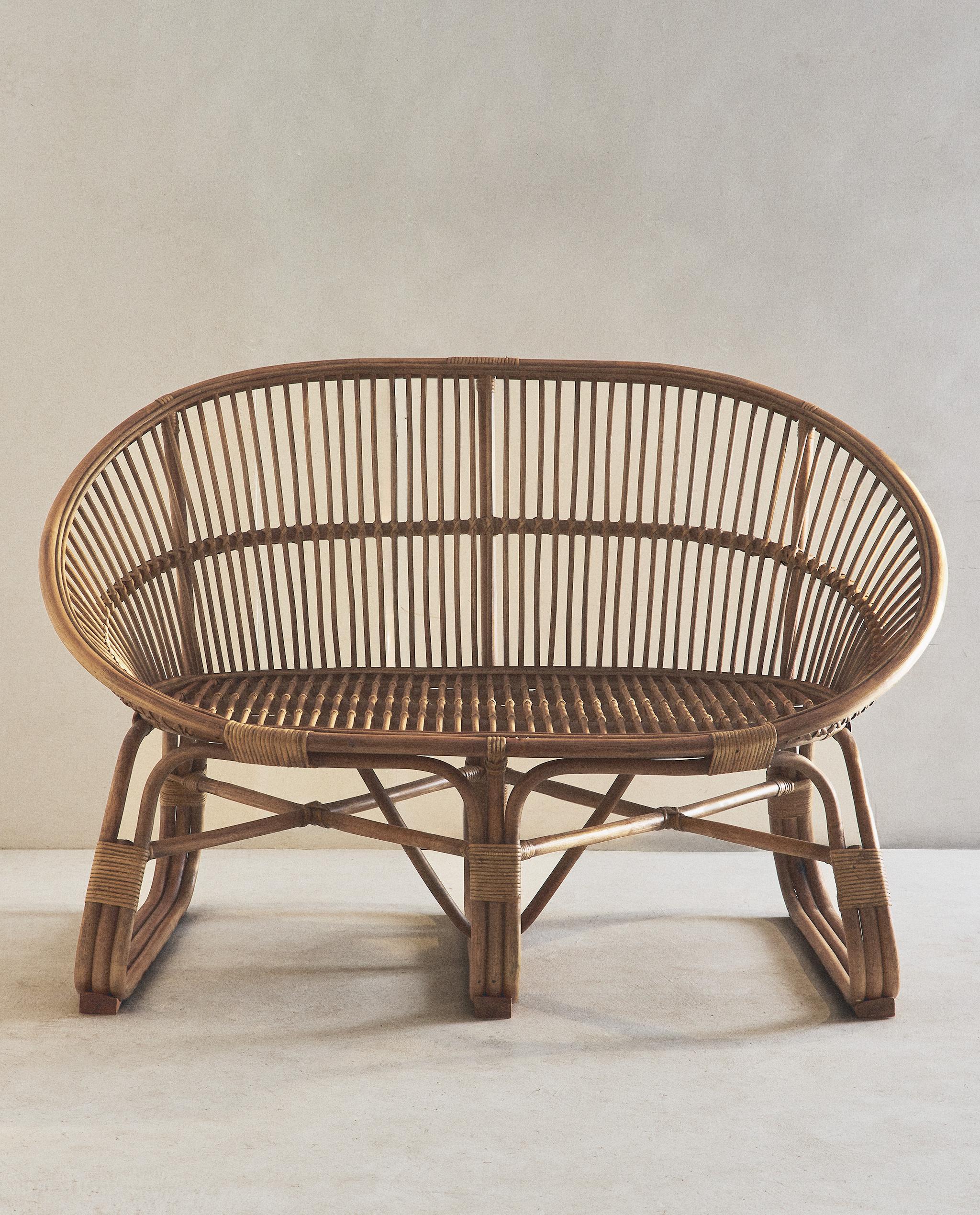 RATTAN COUCH AND STRIPED CUSHION