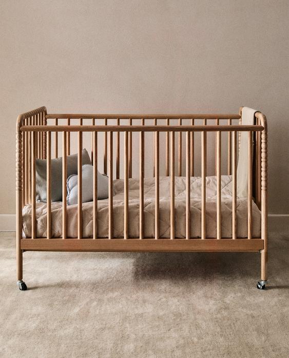 CARVED WOODEN COT WITH WHEELS