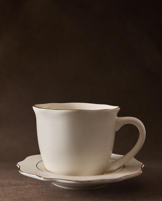 PORCELAIN TEACUP AND SAUCER WITH RIM DETAIL