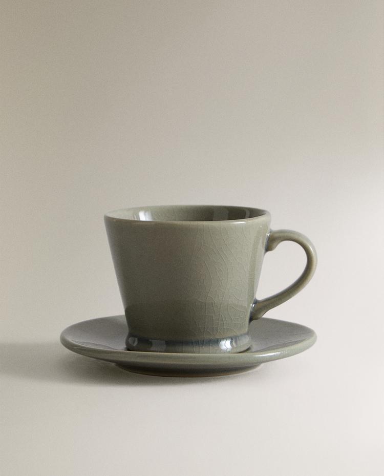 GLAZED STONEWARE TEACUP AND SAUCER