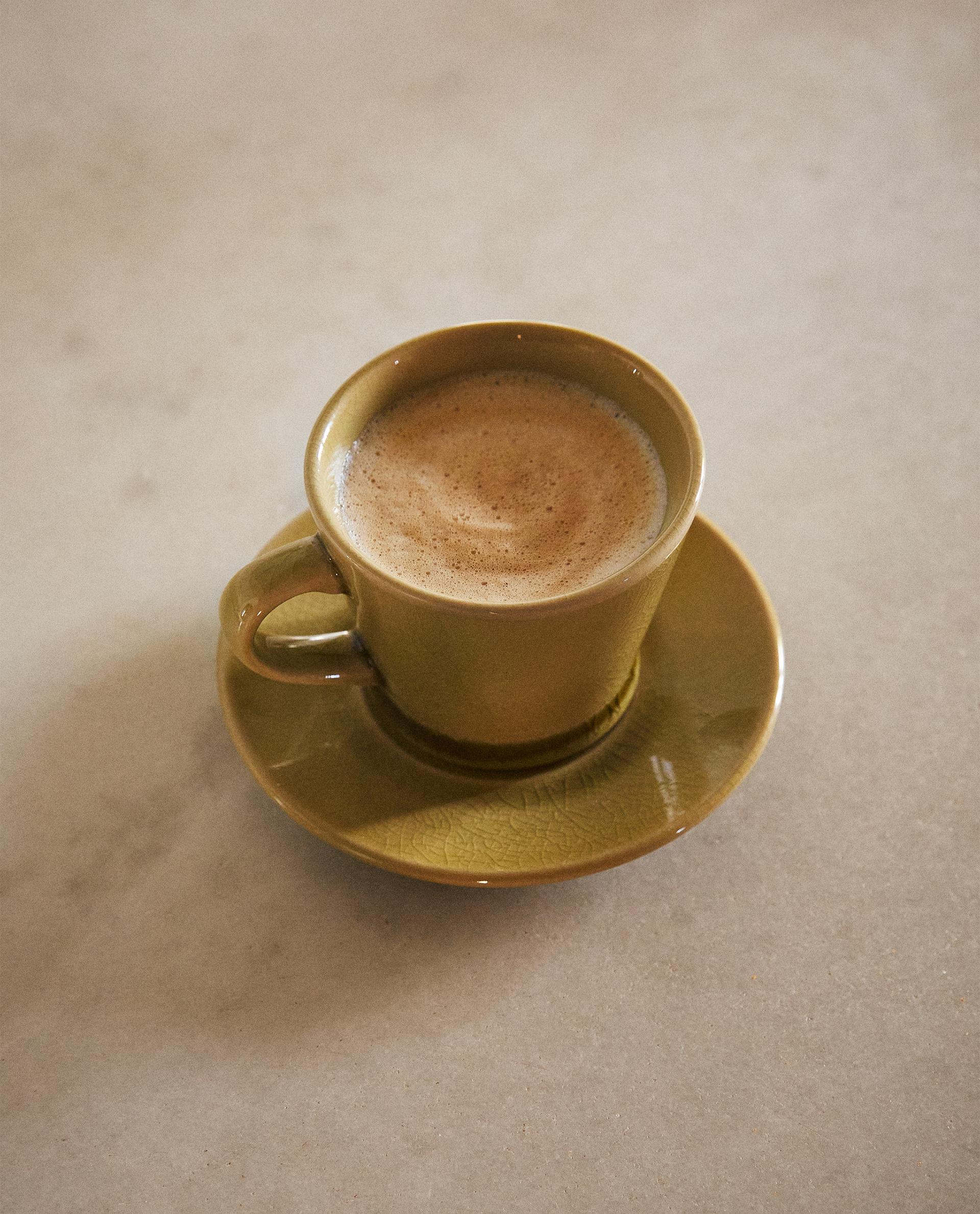 GLAZED STONEWARE TEACUP AND SAUCER