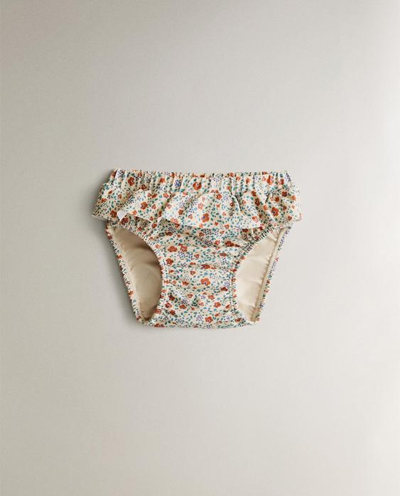 BABY-STRAND-ÜBERHOSE MIT BLUMEN-VOLANT