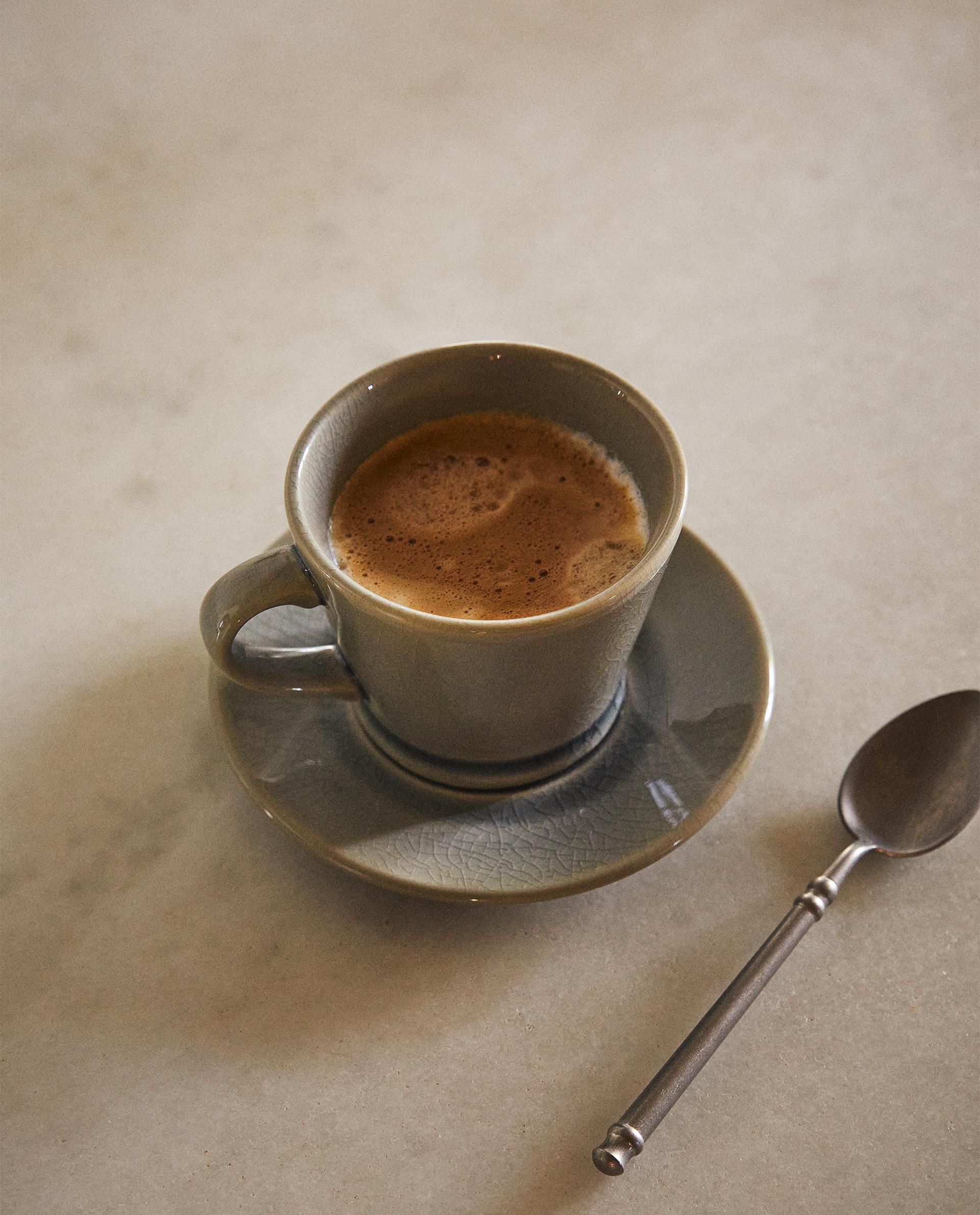 GLAZED STONEWARE TEACUP AND SAUCER