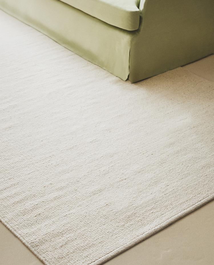 LIGHT-COLOURED WOOL RUG LIGHT-COLOURED WOOL RUG