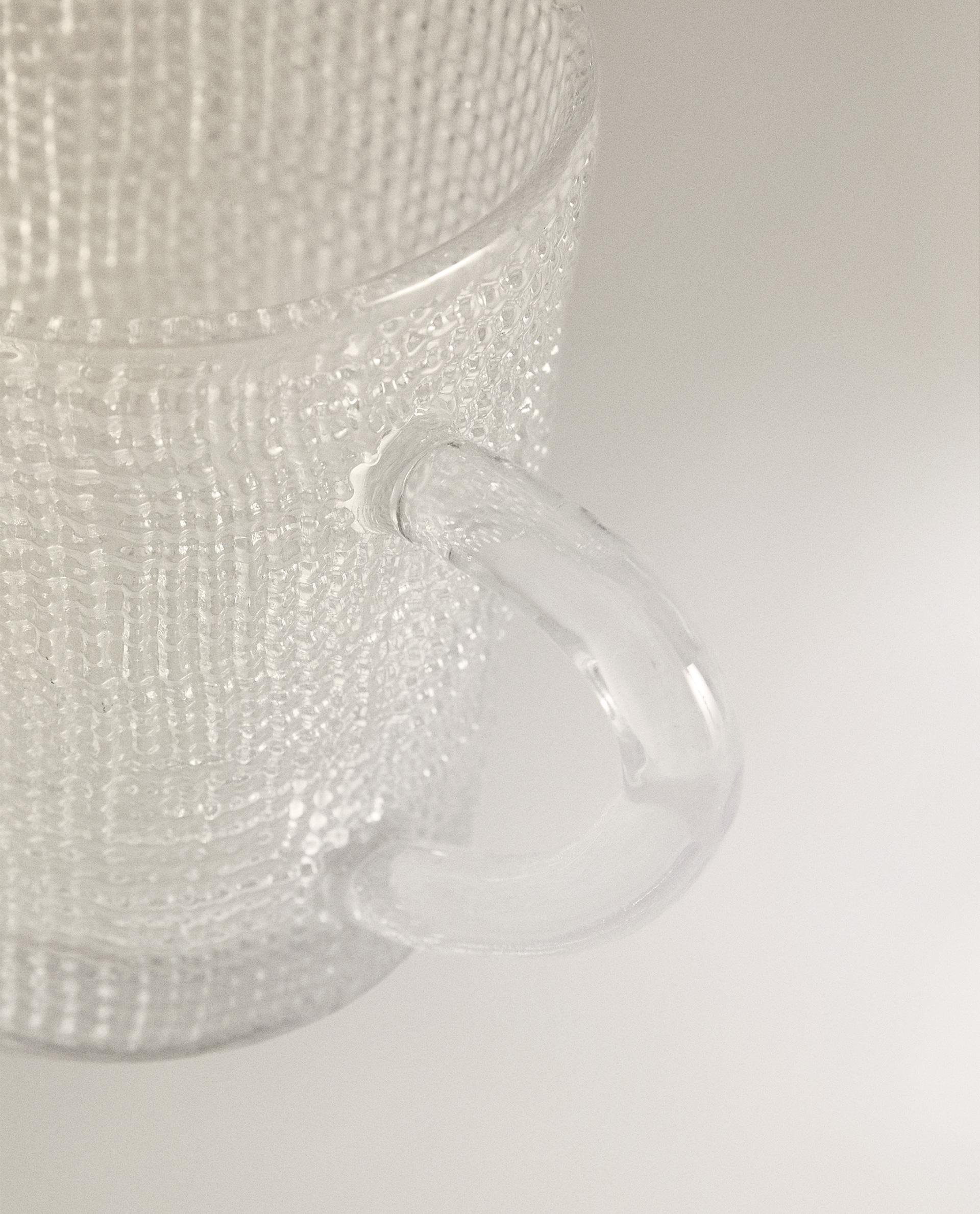 GLASS CUP WITH RAISED DESIGN