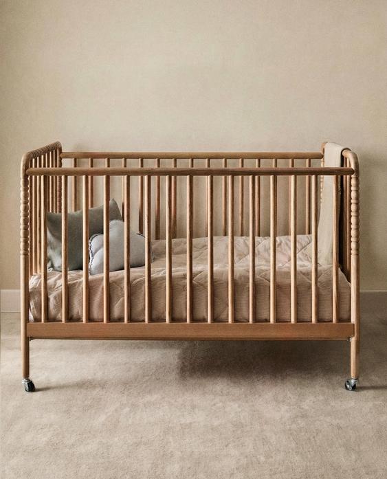 CARVED WOODEN COT WITH WHEELS