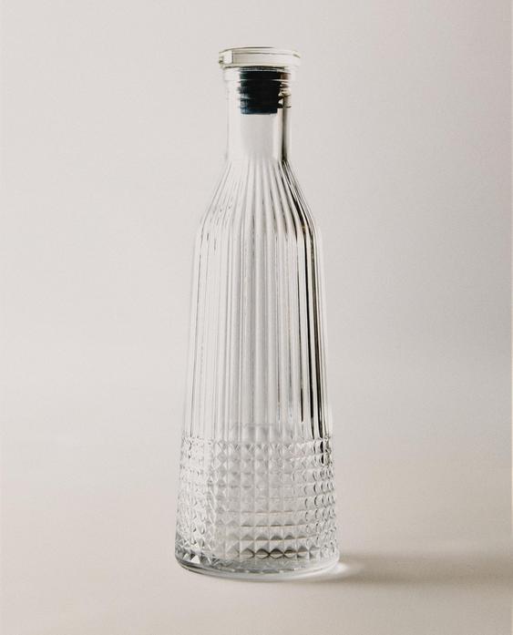 GLASS BOTTLE WITH RELIEF DESIGN