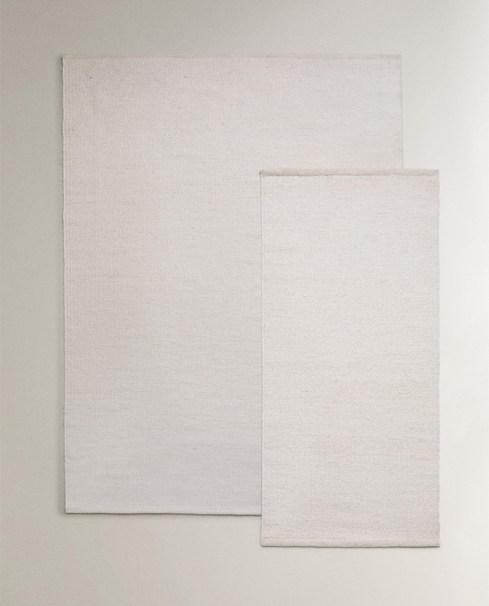 LIGHT-COLOURED WOOL RUG LIGHT-COLOURED WOOL RUG