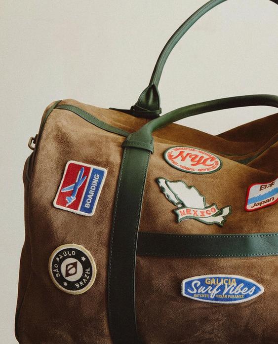 TRAVEL BAG WITH PATCHES