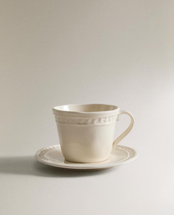 RAISED STONEWARE COFFEE CUP AND SAUCER